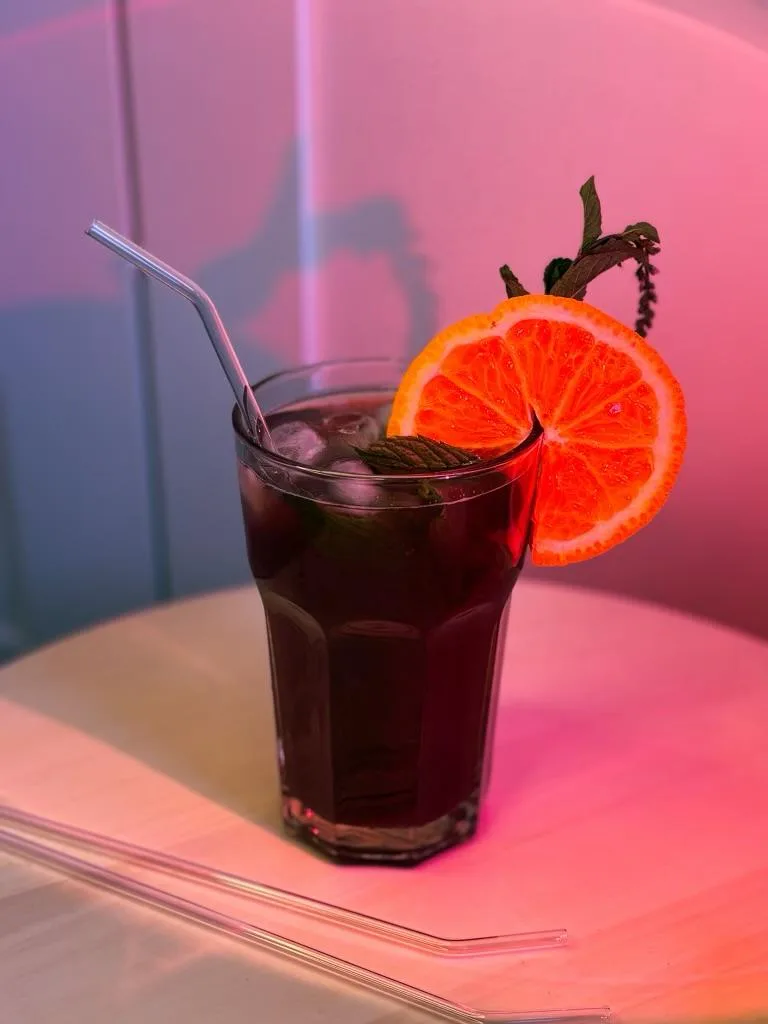 Bent glass straw in a drink with orange